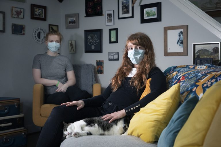 two women with masks at home