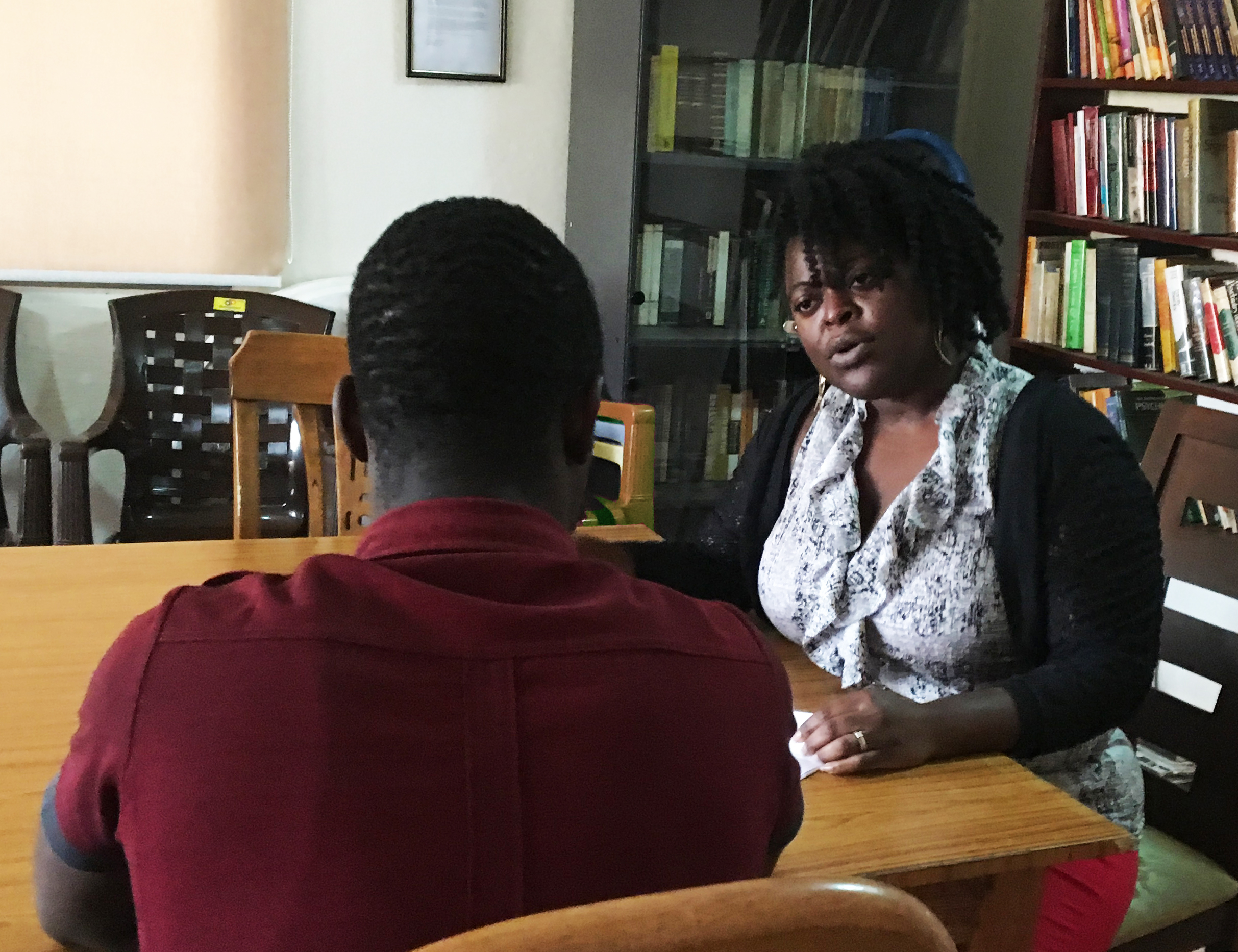 Trainee speaking with a patient in Uganda