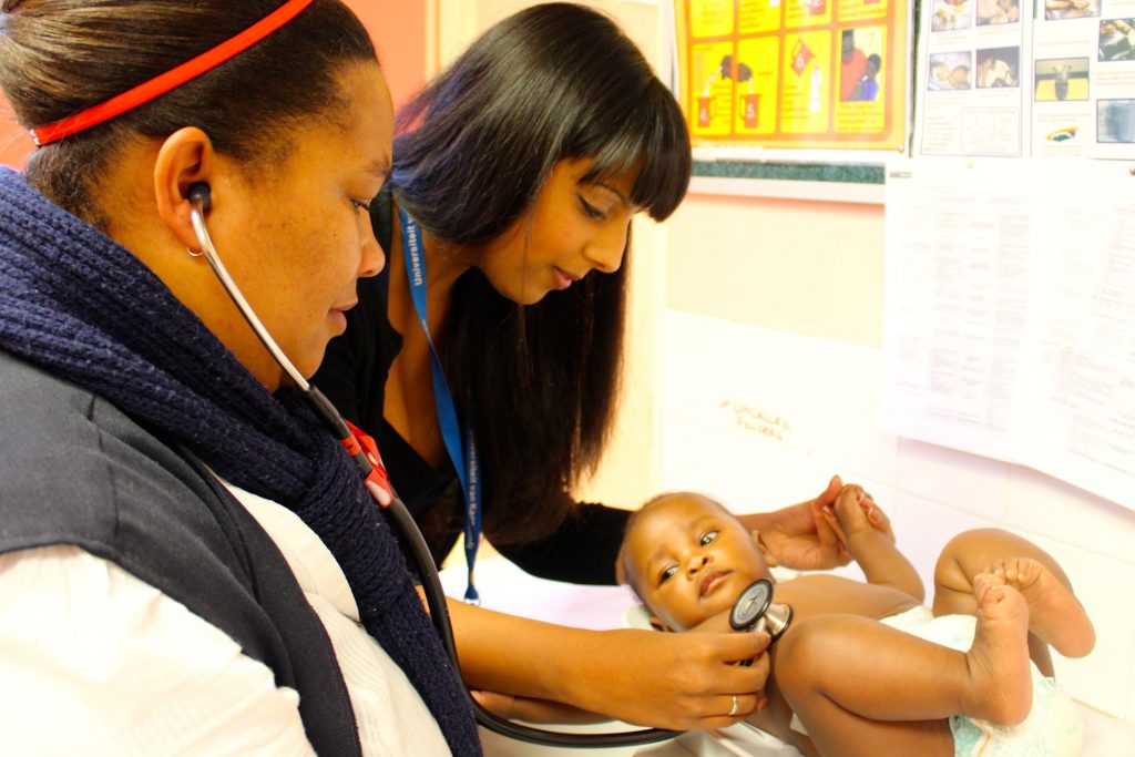 UJMT Trainee Bhakti Hansoti examining a child in South Africa.