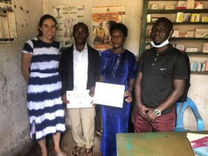 Uganda-malaria-Shelus-with-two-vendors-holding-training-certifications